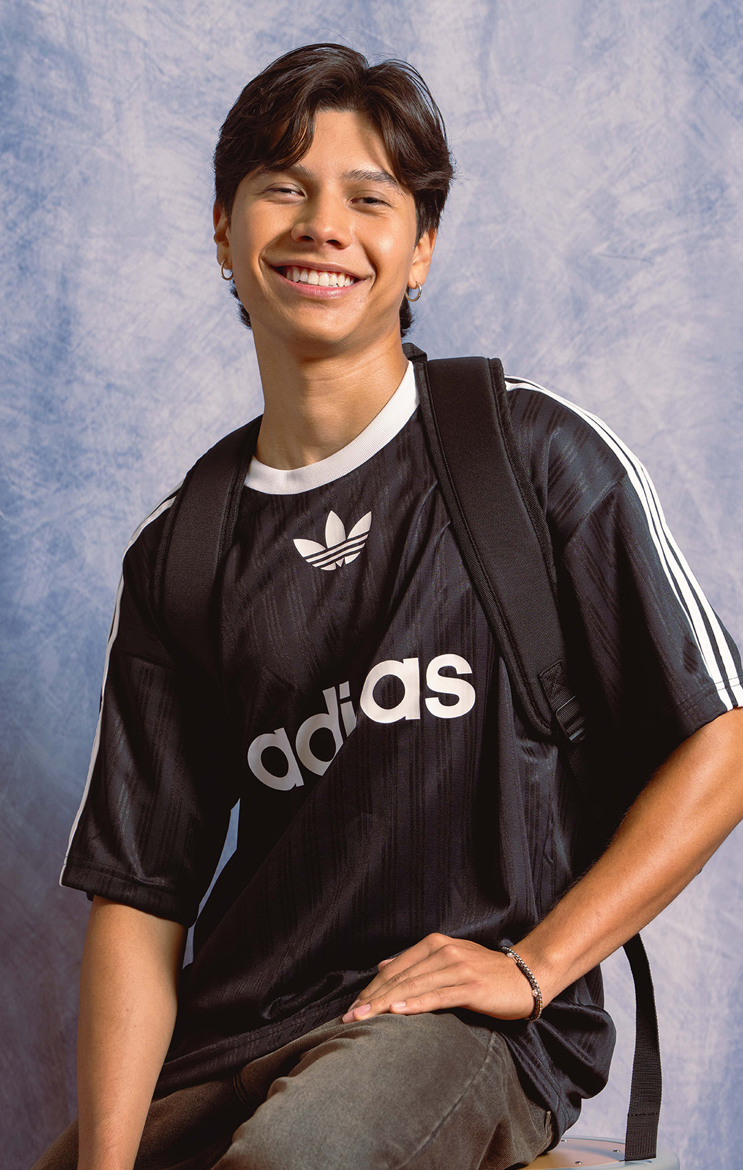 Kid in Adidas shirt