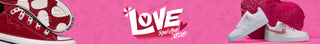 White sneakers with red soles on a pink background with 'LOVE' text.